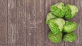 Green vegetables. Pile of cabbage on the wooden background. Top view