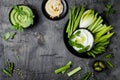 Green vegetables snack board with various dips. Yogurt sauce or labneh, hummus, herb hummus or pesto with fresh vegetables.