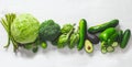 Green vegetables on a white background. Flat lay series of assorted green vegetables