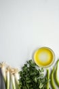 Green vegetables on white background: onion, parsley, olive oil, paprika Royalty Free Stock Photo