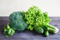 Green vegetables on a wooden table. Salad, broccoli, spinach, ce Royalty Free Stock Photo