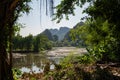 Green Vegitation with Lake in Foreground and green mountains in the background with blue skies in Vietnam