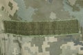 Green velcro on spotted military clothing Royalty Free Stock Photo