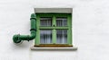 green ventilation pipe along white wall . Royalty Free Stock Photo