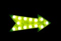 Green vintage arrow with light bulbs on seamless black background