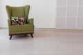 Green vintage chair with flowers in an empty white room Royalty Free Stock Photo