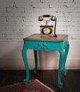 Green vintage wooden table and old golden telephone set Royalty Free Stock Photo