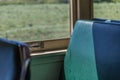 Green vinyl train car seat in the sun Royalty Free Stock Photo