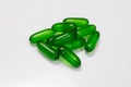 Green vitamin E softgel capsules with white background Royalty Free Stock Photo