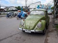 A green volkswagen beetle is parked Royalty Free Stock Photo