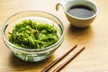 Green wakame. Seaweed salad and soy sauce in bowl