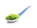 Green wakame. Seaweed salad in spoon isolated on white background