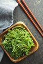 Green wakame. Seaweed salad in wooden bowl