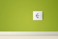 Green wall with european electric outlet Royalty Free Stock Photo