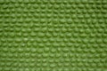 A green wall of oval cobble stones masonry. rough surface of the wall. pebble stone texture Royalty Free Stock Photo