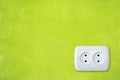 Green wall with white electric outlet Royalty Free Stock Photo