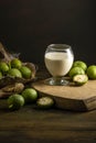 green walnut kernels leaves wooden table oil nuts unripe husks healthy food drink, old rustic table Background Harvest, organic Royalty Free Stock Photo