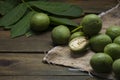 green walnut kernels leaves wooden table oil nuts unripe husks healthy food drink, old rustic table Background Harvest, organic Royalty Free Stock Photo