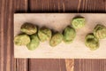 Green wasabi peanut on brown wood