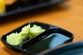 green wasabi.traditional japanese local garnish for sashimi.wasabi for delicious seafood sushi on black plate.wasabi for customer Royalty Free Stock Photo