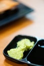 green wasabi.traditional japanese local garnish for sashimi.wasabi for delicious seafood sushi on black plate.wasabi for customer Royalty Free Stock Photo