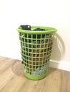 Green wash basket with dirty washing inside