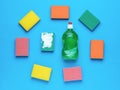 Green washing gel and a set of foam sponges on a blue background. Minimal concept of washing and cleaning Royalty Free Stock Photo