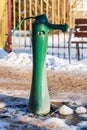 Green water pump on a sunny winter day Royalty Free Stock Photo