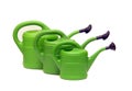 Green watering cans on white