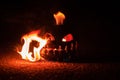 Green watermelon burns with fiery flame on the scary holiday halloween