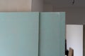 Green waterproof drywall or greenboard. Paper faced gypsum board, moisture proof plasterboard building material.