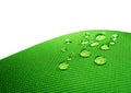 Green waterproof fabric with waterdrops close up on white Royalty Free Stock Photo