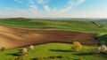 Green wavy hills with agricultural fields