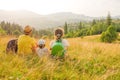 Happy young family sitting back view mountain family nature vacation green travel together nature child mountain kid Royalty Free Stock Photo