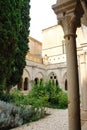 The green, well-kept courtyard and carved stone arches of the Poblet monastery cat. Reial Monestir de