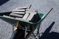 A green wheelbarrow filled with curbs from the front Royalty Free Stock Photo