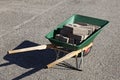 A green wheelbarrow filled with curbs Royalty Free Stock Photo