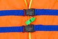 Green whistle on part of life jacket