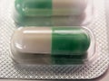 Green and white antidepressant pill in packet unopened