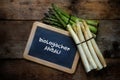 Green and white asparagus and a blackboard with german text bio Royalty Free Stock Photo