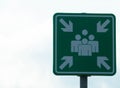 Evacuation assembly point sign in green and white. Gathering point board to lead people to a safe place during an emergency. Place Royalty Free Stock Photo