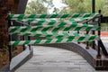 Green and white barrier tape on a disabled walkway