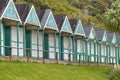 The old green painted Victorian Beach Huts at Langland Bay in South Wales Royalty Free Stock Photo