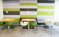 Green and white chairs and tables in modern cafeteria