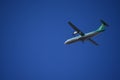 Green and White Double Helix Regional Airplane Flying Left