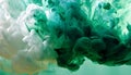 Green and white ink diffusing in water, forming swirling clouds. Royalty Free Stock Photo