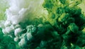 Green and white ink diffusing in water, forming swirling clouds. Royalty Free Stock Photo