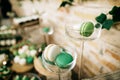 Green and white Macarons on dessert table in glass trays Royalty Free Stock Photo
