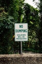 "No Dumping" warning sign, violators will be prosecuted