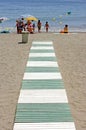 Green and white path leading to beach in Spain